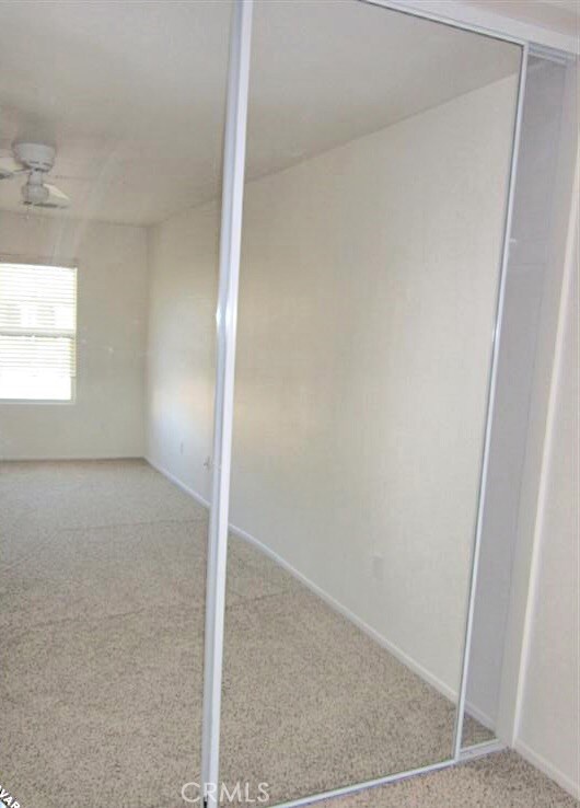 carpeted empty room with ceiling fan