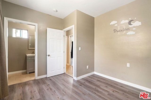 unfurnished bedroom with light wood-type flooring