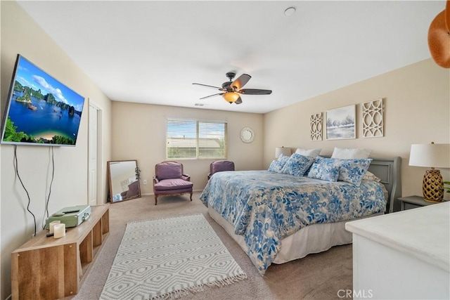 bedroom with ceiling fan and light carpet