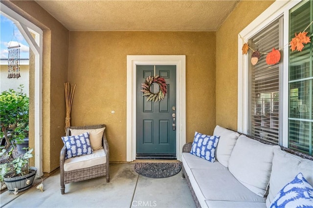 doorway to property featuring stucco siding