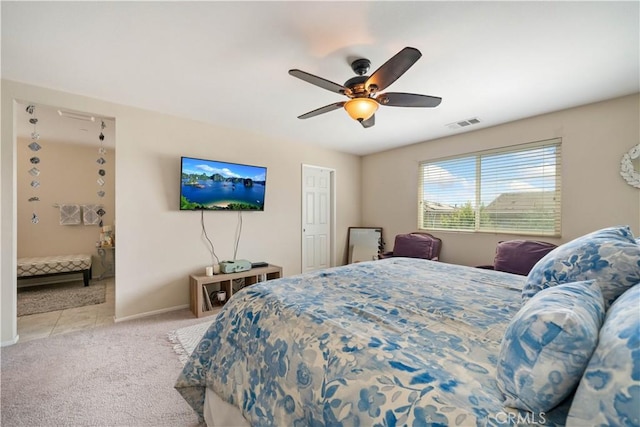 carpeted bedroom featuring a ceiling fan, baseboards, and visible vents