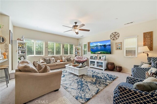 living room with ceiling fan and light colored carpet