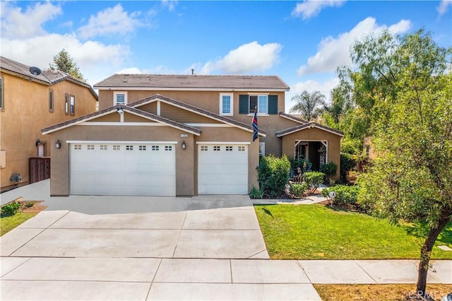traditional-style house featuring a front yard, driveway, stucco siding, and an attached garage