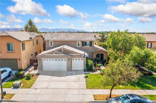 view of front of house with a mountain view and a garage