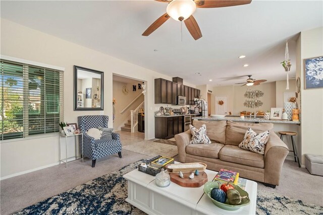 carpeted living room featuring ceiling fan