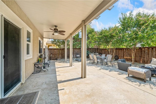 view of patio with outdoor dining area, a fenced backyard, and ceiling fan