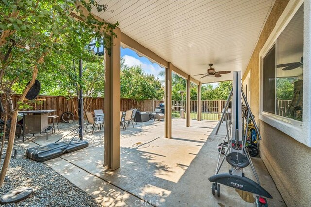 view of patio with a fenced backyard, an outdoor living space, outdoor dining space, and a ceiling fan