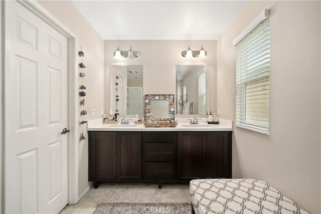 full bathroom featuring double vanity and a sink