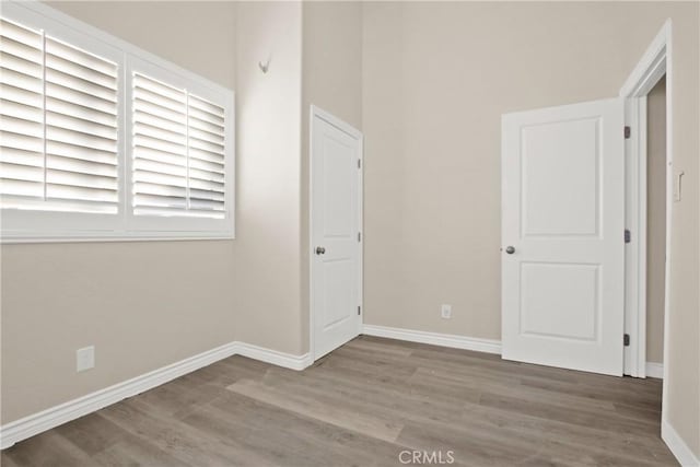 unfurnished room featuring hardwood / wood-style flooring