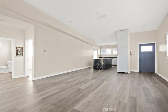 unfurnished living room with light wood-type flooring