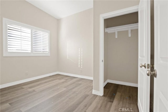 unfurnished bedroom with a closet and light hardwood / wood-style flooring