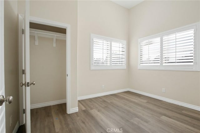 unfurnished bedroom with a closet and light hardwood / wood-style floors