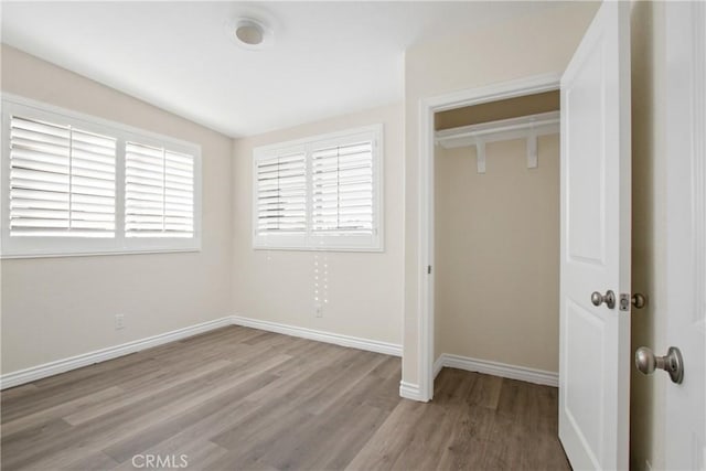 unfurnished bedroom featuring light hardwood / wood-style floors and a closet