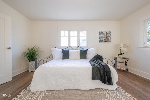 bedroom with dark hardwood / wood-style floors