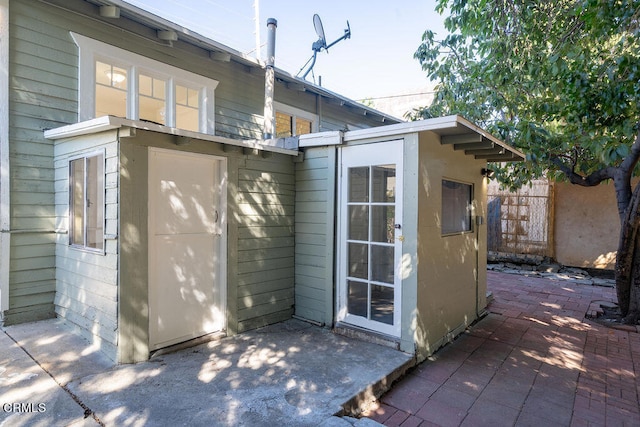 exterior space featuring a storage shed and a patio