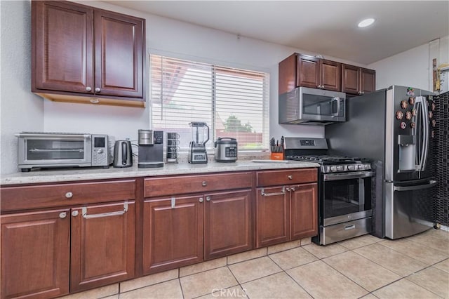 kitchen featuring light tile patterned floors and appliances with stainless steel finishes