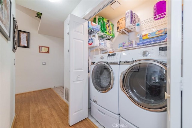 laundry area featuring light hardwood / wood-style flooring and independent washer and dryer