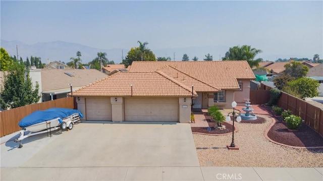 view of front of property with a mountain view and a garage