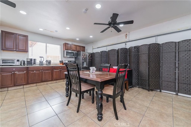 dining space featuring ceiling fan and light tile patterned flooring