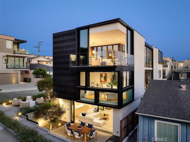 back of house with a patio and a balcony