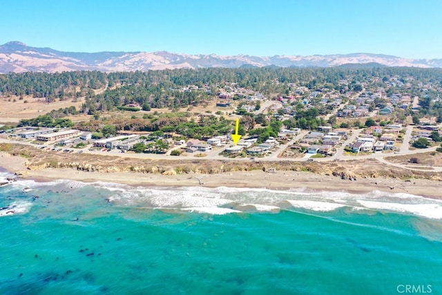 birds eye view of property with a view of the beach and a water and mountain view