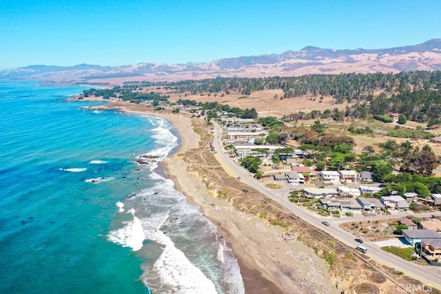 aerial view featuring a beach view and a water and mountain view