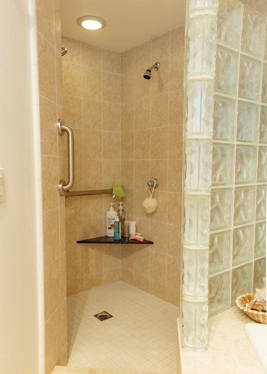 bathroom with tiled shower