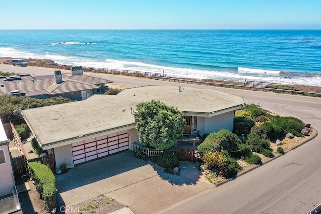 birds eye view of property with a water view and a view of the beach