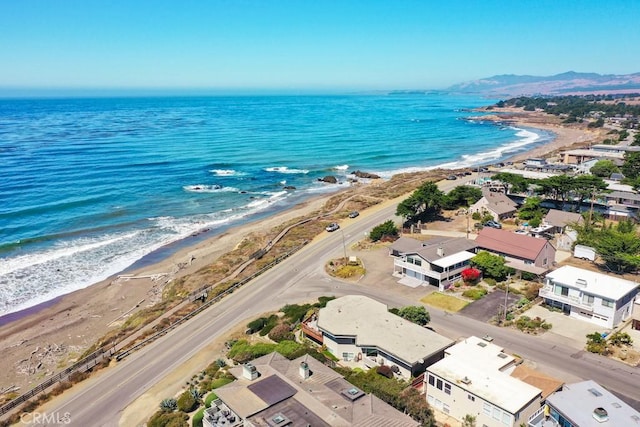 birds eye view of property with a water view and a view of the beach