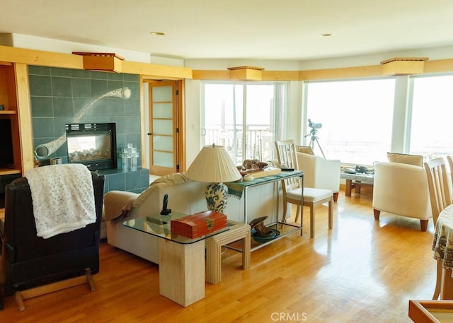 sitting room featuring a tile fireplace and hardwood / wood-style floors