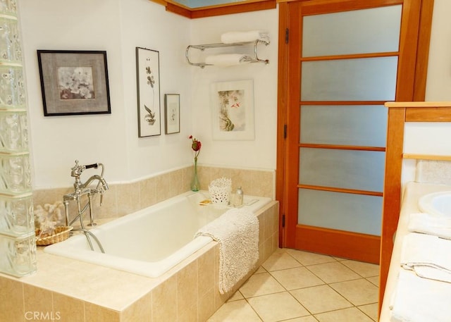 bathroom featuring tiled tub and tile patterned flooring