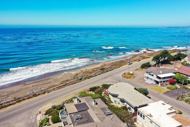 bird's eye view featuring a water view and a beach view