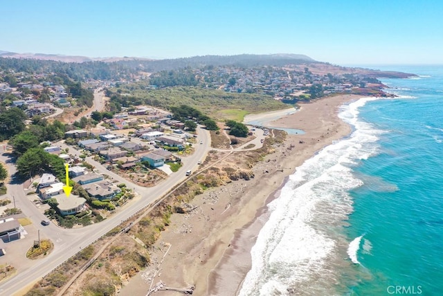 birds eye view of property featuring a beach view and a water view