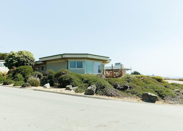 view of property exterior featuring a deck