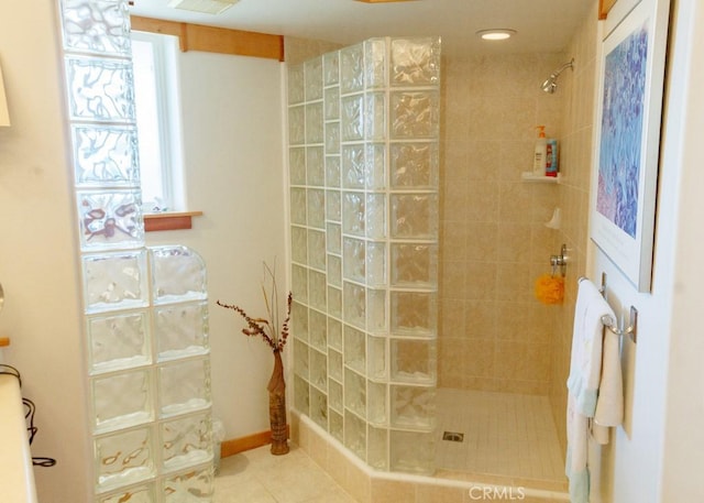 bathroom featuring tile patterned flooring and tiled shower