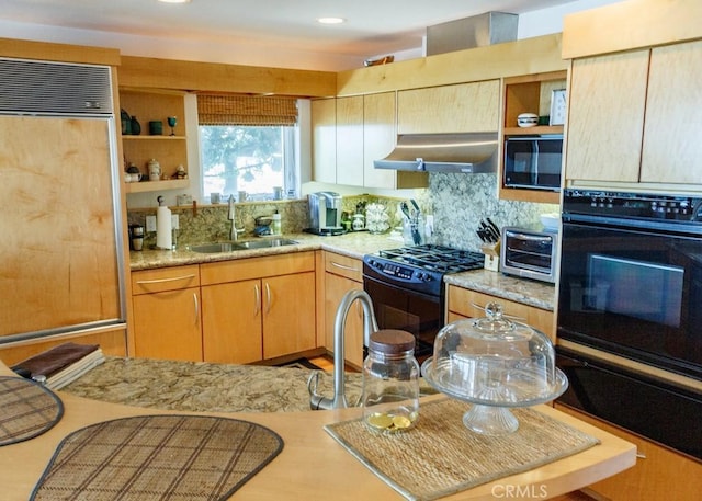 kitchen with decorative backsplash, light stone countertops, extractor fan, black appliances, and sink