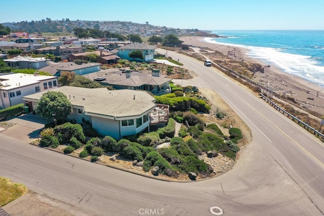 drone / aerial view featuring a view of the beach and a water view