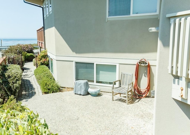 exterior space with a water view and a patio