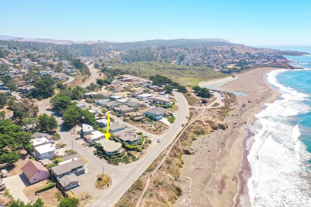 drone / aerial view with a water view and a beach view