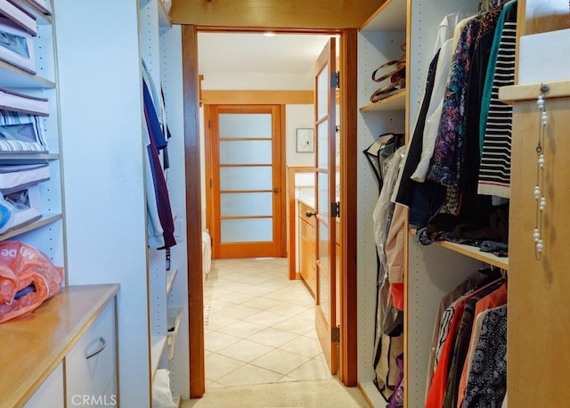 spacious closet featuring light tile patterned floors