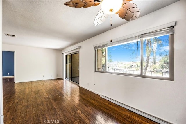 unfurnished room featuring a textured ceiling, dark hardwood / wood-style floors, ceiling fan, and a baseboard radiator