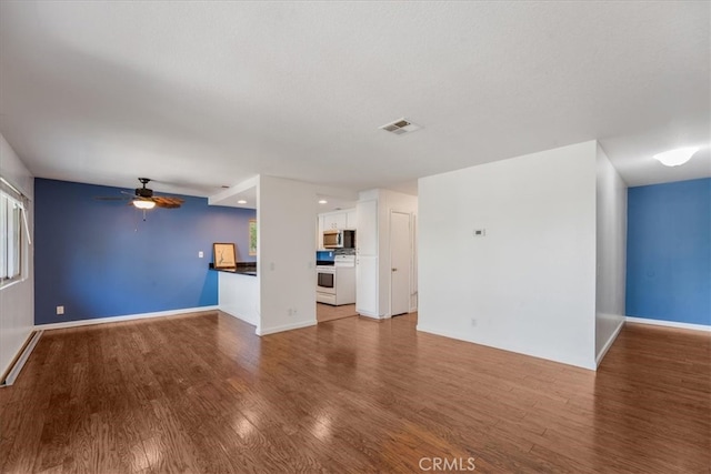 unfurnished living room with ceiling fan and hardwood / wood-style flooring