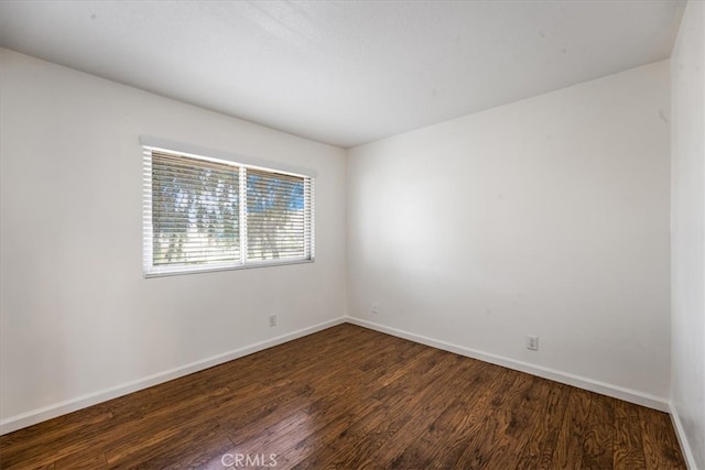 spare room with dark hardwood / wood-style floors