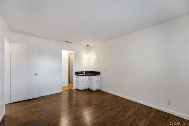 empty room with dark wood-type flooring