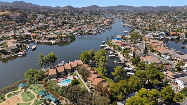 drone / aerial view featuring a water and mountain view