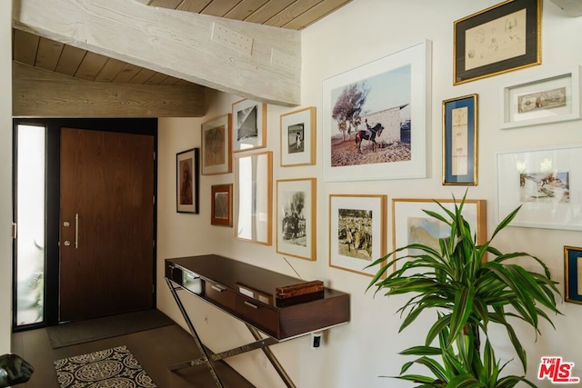 entryway with beamed ceiling and wooden ceiling