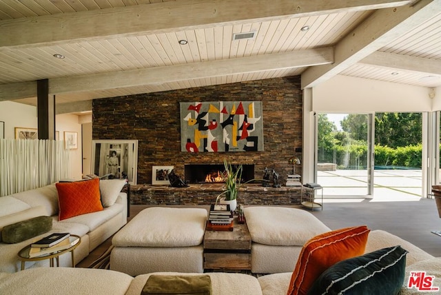 living room featuring lofted ceiling with beams, a stone fireplace, and wood ceiling