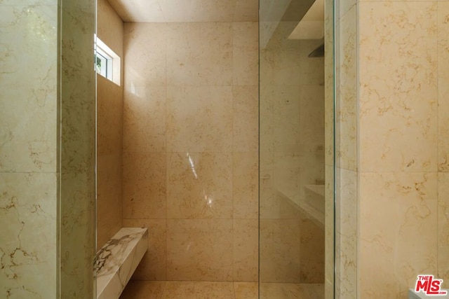 bathroom with tiled shower