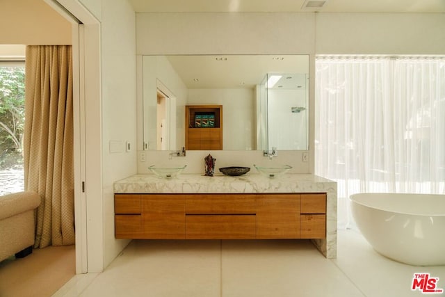 bathroom featuring vanity and a bath