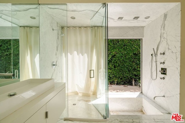 bathroom featuring vanity and an enclosed shower